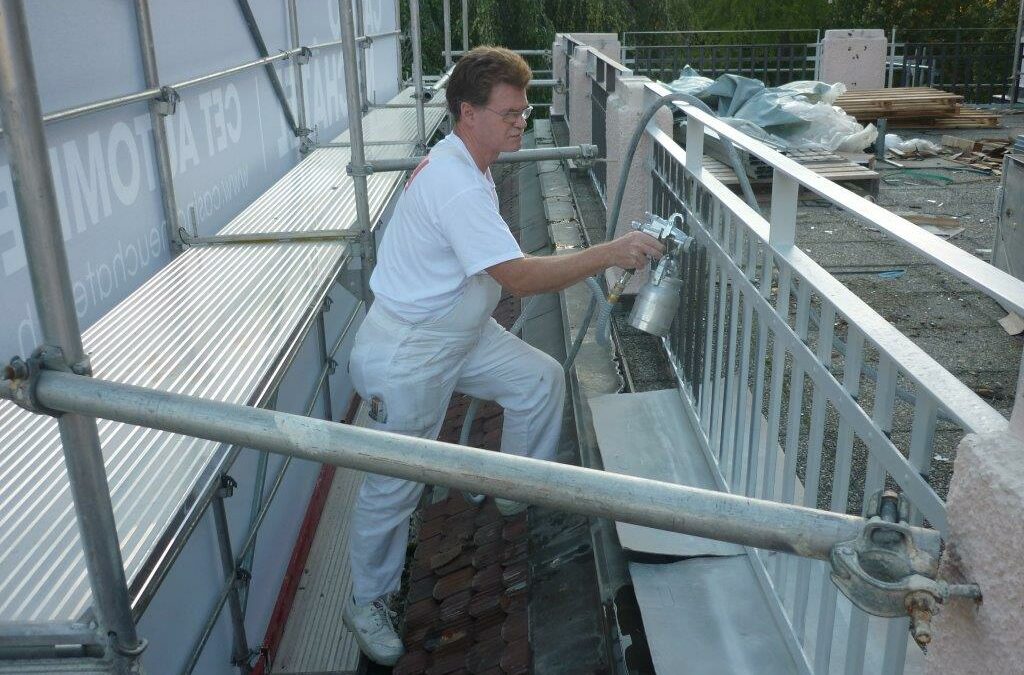 Application au pistolet HVLP de peinture antirouille sur barrières terrasse du Casino de la Rotonde